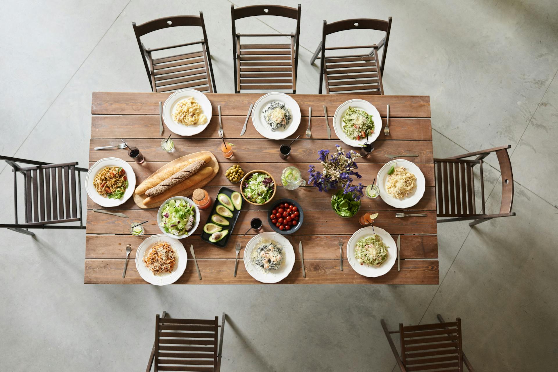 table-with-plates-of-food-and-chairs